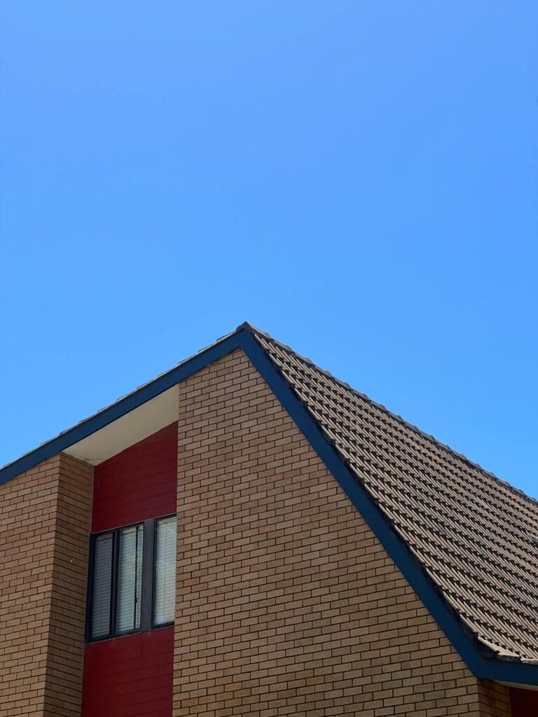 A minimalist view of a modern building facade against a clear blue sky in North Wollongong, NSW, Australia.